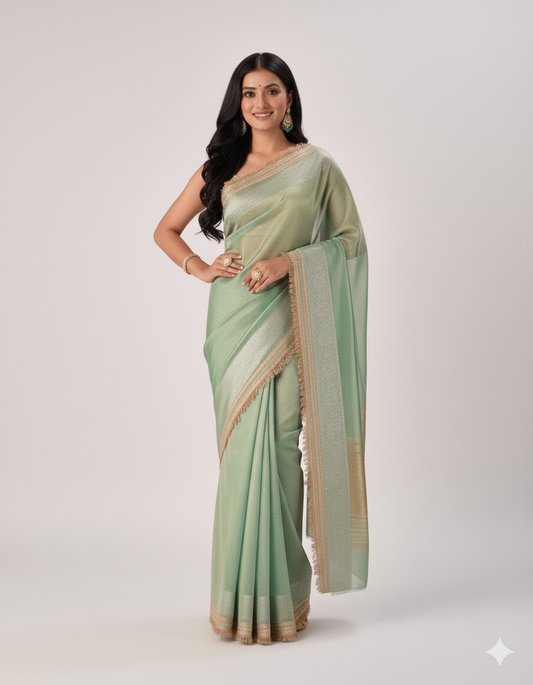 Woman wearing a light green saree with a white background